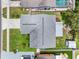 Aerial view of a single-Gathering home with a gray roof, green lawn, and a shed in the backyard at 12920 124Th Ave, Largo, FL 33774