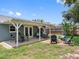 Large backyard with patio, manicured lawn, outdoor dining, and a firepit at 12920 124Th Ave, Largo, FL 33774