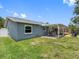 The home features a spacious backyard with a covered patio for dining, and a separate firepit area at 12920 124Th Ave, Largo, FL 33774