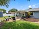 The backyard features a covered patio, a fire pit with seating, and well-maintained landscaping at 12920 124Th Ave, Largo, FL 33774