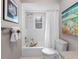 Bright bathroom featuring a white shower-over-tub, and decorative artwork at 12920 124Th Ave, Largo, FL 33774