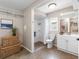 Well-lit bathroom featuring a walk-in shower, vanity, and shelving for a clean and functional space at 12920 124Th Ave, Largo, FL 33774