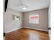 Cozy bedroom featuring hardwood floors, neutral walls, ceiling fan, and bright window at 12920 124Th Ave, Largo, FL 33774