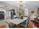 Open-concept dining room with views into the kitchen and living spaces, with modern light fixture at 12920 124Th Ave, Largo, FL 33774