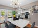 Bright dining area featuring access to the backyard, an elegant chandelier, and kitchen view at 12920 124Th Ave, Largo, FL 33774