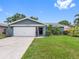 Charming single-story home with a well-maintained lawn and attached two-car garage at 12920 124Th Ave, Largo, FL 33774