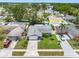 Charming single-story home with a manicured lawn, driveway, and colorful landscaping at 12920 124Th Ave, Largo, FL 33774
