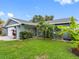 Charming single-story home with a well-manicured lawn and beautiful landscaping at 12920 124Th Ave, Largo, FL 33774