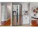 Spacious kitchen with a stainless steel refrigerator and white cabinets at 12920 124Th Ave, Largo, FL 33774