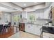 Stylish kitchen with white cabinets, stainless steel appliances, and an adjacent dining area at 12920 124Th Ave, Largo, FL 33774