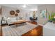 Bright living room with hardwood floors, stylish rug, and comfortable seating area at 12920 124Th Ave, Largo, FL 33774