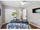 Stylish office with hardwood floors, modern desk, built-in shelving, and ceiling fan at 12920 124Th Ave, Largo, FL 33774