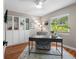 Stylish office with hardwood floors, modern desk, bright natural light, and built-in shelving at 12920 124Th Ave, Largo, FL 33774