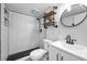Updated bathroom boasts stylish fixtures, subway tile shower, unique shelves, and modern vanity at 1301 S Howard Ave # A22, Tampa, FL 33606