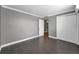 Bedroom showcases wood-look floors, neutral paint, and closet with an open door to the hallway at 1301 S Howard Ave # A22, Tampa, FL 33606