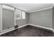 Bedroom features wood-look tile flooring, a window for light, and painted in a neutral color at 1301 S Howard Ave # A22, Tampa, FL 33606
