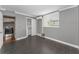 Bedroom features wood-look tile flooring and a window for light, door to hallway, and closet to the center at 1301 S Howard Ave # A22, Tampa, FL 33606