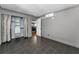 Bedroom features wood-look tile floors, modern closet, and a view into the kitchen at 1301 S Howard Ave # A22, Tampa, FL 33606