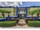 Inviting building entrance with lush greenery, concrete path, and secure access at 1301 S Howard Ave # A22, Tampa, FL 33606