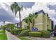 1301 SoHo Condominiums with manicured landscaping, mature palm trees, and sunny skies at 1301 S Howard Ave # A22, Tampa, FL 33606