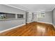 Bright living room featuring hardwood floors, a breakfast bar, white shelves, and natural light from the window at 1301 S Howard Ave # A22, Tampa, FL 33606