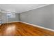 Bright living room features hardwood floors, a window for natural light, and neutral wall colors at 1301 S Howard Ave # A22, Tampa, FL 33606