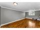 Spacious living room boasts hardwood floors, a window for natural light, and freshly painted gray walls at 1301 S Howard Ave # A22, Tampa, FL 33606