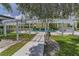 Community pool area featuring a white pergola, lounge chairs, and surrounding greenery at 1301 S Howard Ave # A22, Tampa, FL 33606