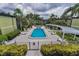 Overhead view of the community pool area surrounded by landscaping and lounge chairs at 1301 S Howard Ave # A22, Tampa, FL 33606
