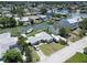 Aerial view of home with canal access, boat dock, and lush landscaping at 13928 Raie Ave, Hudson, FL 34667