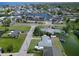 Aerial view showcases single Gathering home on a lot with mature trees and access to deep water canal at 13928 Raie Ave, Hudson, FL 34667