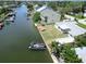 Waterfront property featuring a boat dock and canal access, with lush landscaping and a spacious yard at 13928 Raie Ave, Hudson, FL 34667