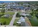 An aerial view showcases the neighborhood with canal access, a marina, and houses with boat docks at 13928 Raie Ave, Hudson, FL 34667