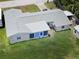 Aerial view of rear of home with white roof and green lawn at 13928 Raie Ave, Hudson, FL 34667