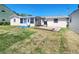 The backyard features a combination of green and dry grass, a shed, and a sunroom attached to the house at 13928 Raie Ave, Hudson, FL 34667