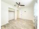 Well-lit bedroom featuring laminate flooring, a ceiling fan, and a closet at 13928 Raie Ave, Hudson, FL 34667