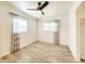 Cozy bedroom featuring laminate flooring, ample natural light, and a ceiling fan at 13928 Raie Ave, Hudson, FL 34667