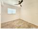 Inviting bedroom with wood-look flooring, a window, and a ceiling fan for added comfort at 13928 Raie Ave, Hudson, FL 34667