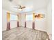 Bright bedroom showcasing laminate flooring, neutral decor, and ample natural light at 13928 Raie Ave, Hudson, FL 34667