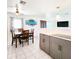 Bright dining area with modern countertops, stainless appliances, and an open view of the TV room at 13928 Raie Ave, Hudson, FL 34667