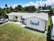 Well-kept single-story home with neat landscaping and a light grey roof at 13928 Raie Ave, Hudson, FL 34667