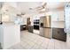 Modern kitchen with stainless steel appliances, sleek countertops, and ample cabinet space at 13928 Raie Ave, Hudson, FL 34667