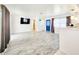 Bright living room featuring wood-look flooring, a flat-screen television and modern decor at 13928 Raie Ave, Hudson, FL 34667