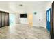 Open living area with wood-look flooring, a sliding glass door, and ample natural light, perfect for relaxing and entertaining at 13928 Raie Ave, Hudson, FL 34667