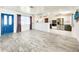 Open living space leading to a modern kitchen, featuring stylish floors and plenty of natural light at 13928 Raie Ave, Hudson, FL 34667
