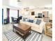 Comfortable open-concept living room with coastal decor, modern appliances, and lots of light at 13928 Raie Ave, Hudson, FL 34667