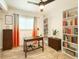 Well-lit office with wood floors, bookshelves, stylish decor, and a large window for natural light at 13928 Raie Ave, Hudson, FL 34667