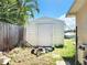 Small white shed in backyard with lawnmower at 13928 Raie Ave, Hudson, FL 34667