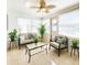 Bright sun room with a ceiling fan, tile floor, multiple windows, and neutral-toned furniture at 13928 Raie Ave, Hudson, FL 34667