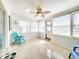 Inviting sunroom featuring tile flooring, bright natural light, and a comfortable seating area at 13928 Raie Ave, Hudson, FL 34667